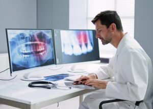 a dental expert at a desk reviewing medical records and radiology images